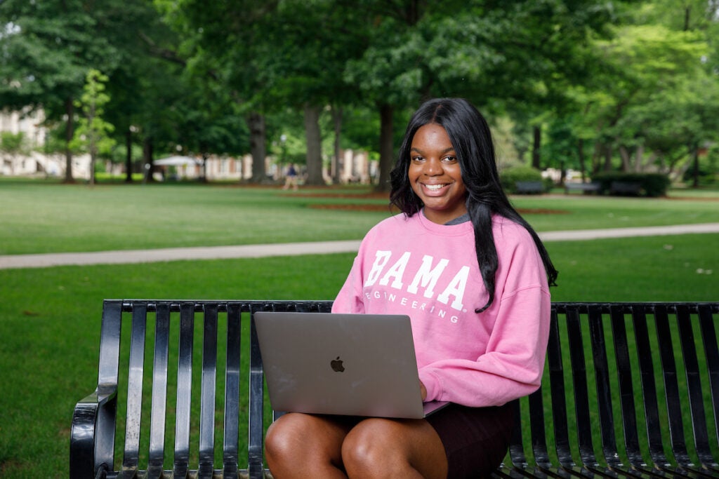 University of Alabama student, Gemia Williams, sitting on a park bench.